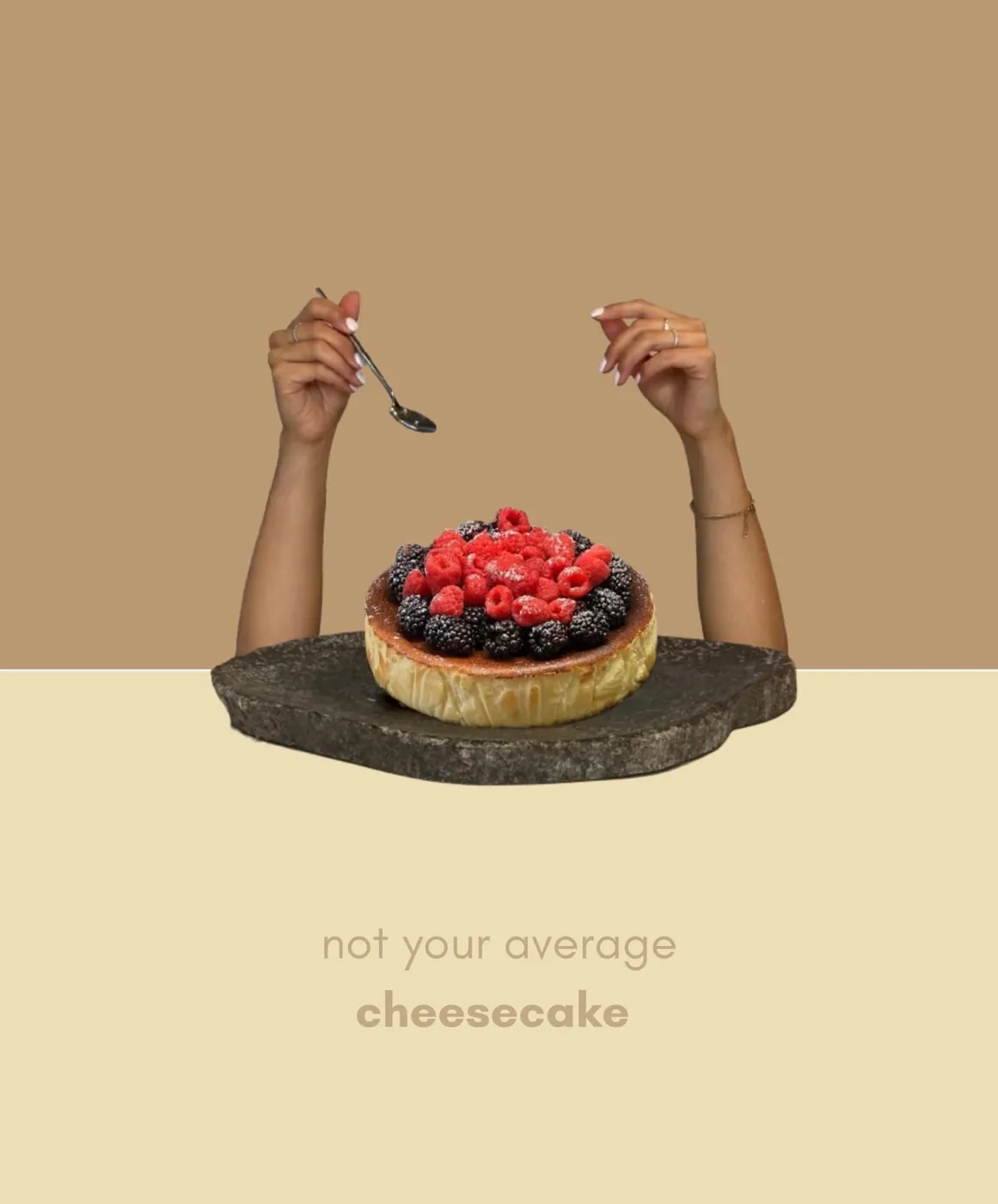 Two hands, one holding a spoon, over a tartza piled with raspberries and blackberries on a stone slab.