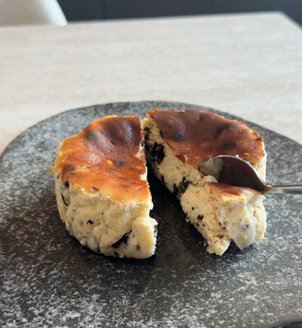An Oreo tartza cut in half, cookie pieces baked through a creamy centre.